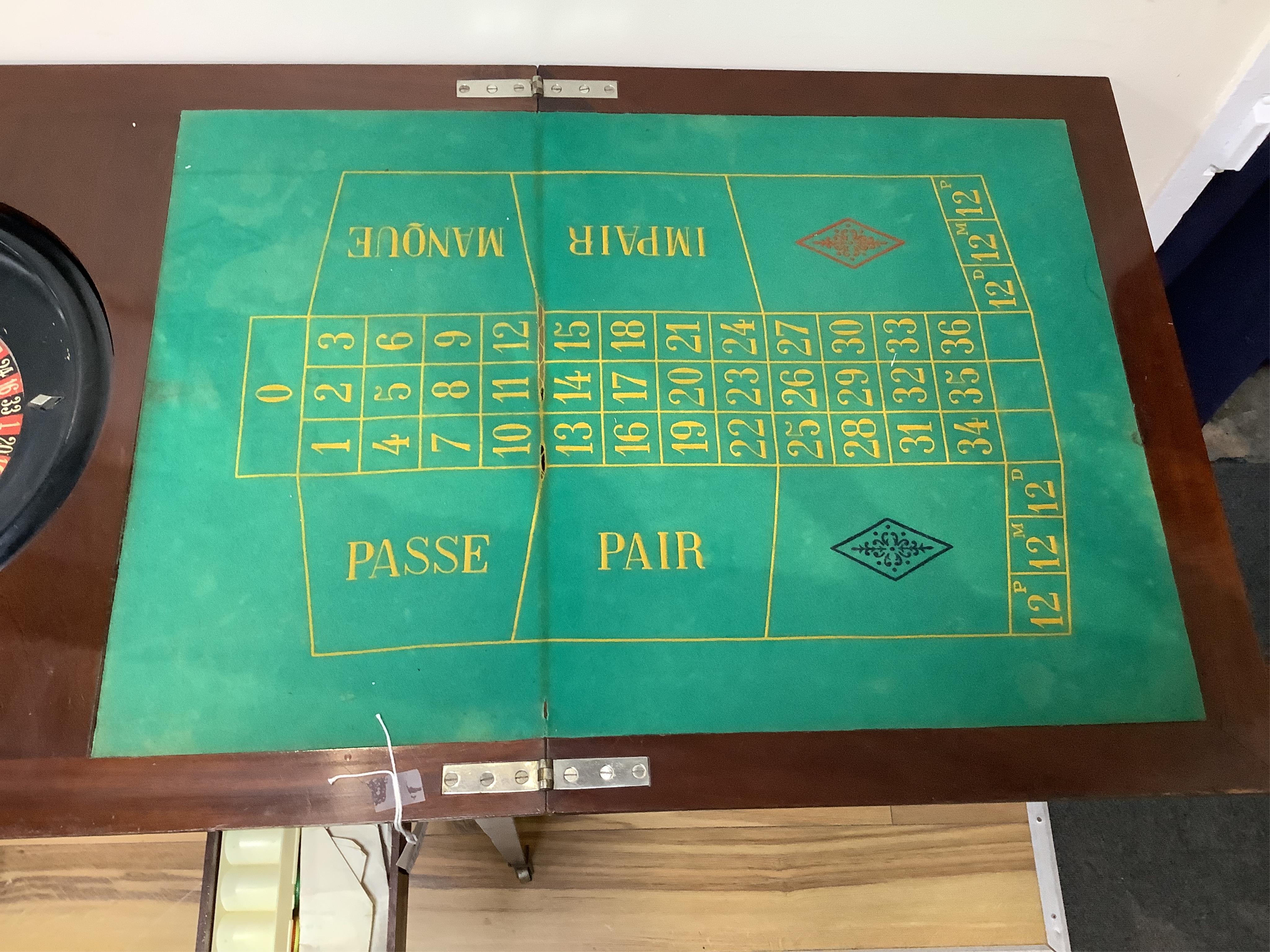 A rectangular mahogany roulette table with twin flap top, width 92cm, depth 57cm, height 77cm